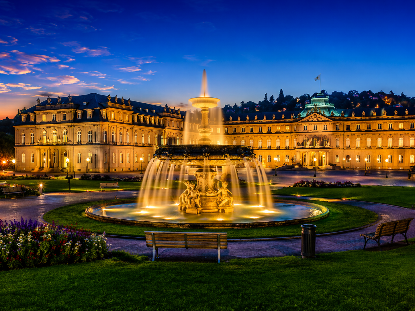 New Palace in Stuttgart with illuminated fountain in the evening